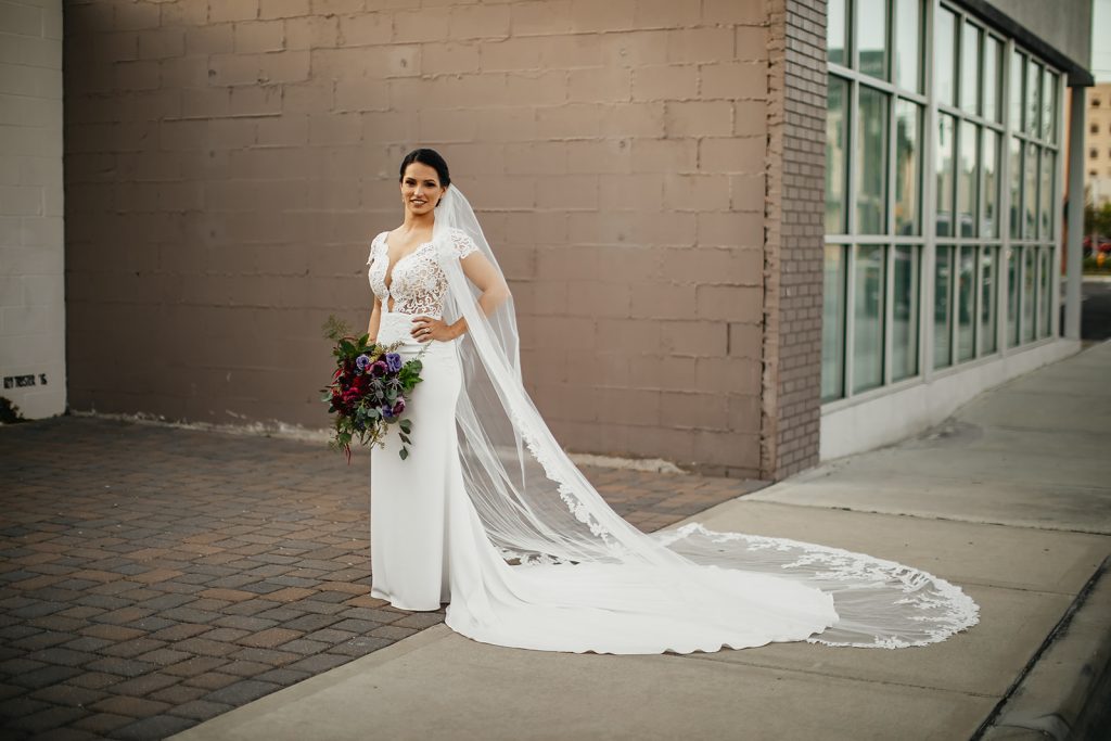 portrait of bride in calla blanche gown with long veil